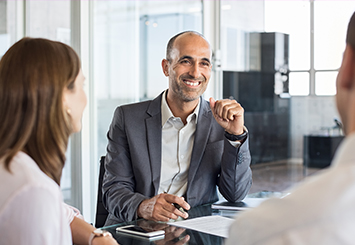 Bank Consulting near syracuse ny image of business man in a meeting with clients from T Gschwender & Associates